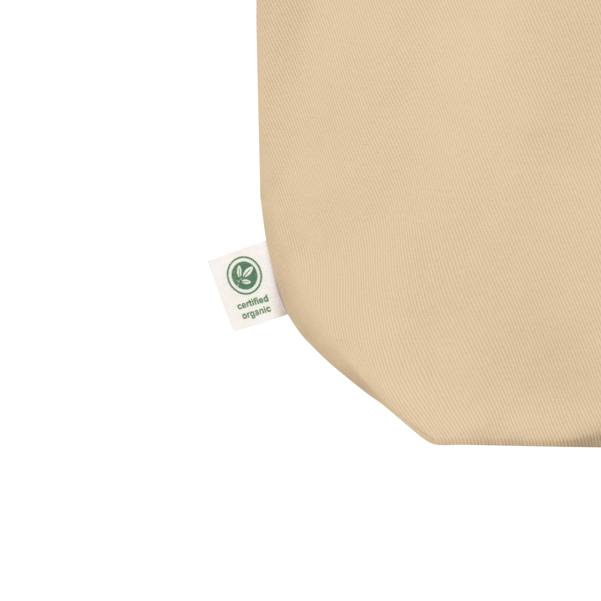 Certified organic tag of cotton tote bag side seam with green eco tag – detail shot