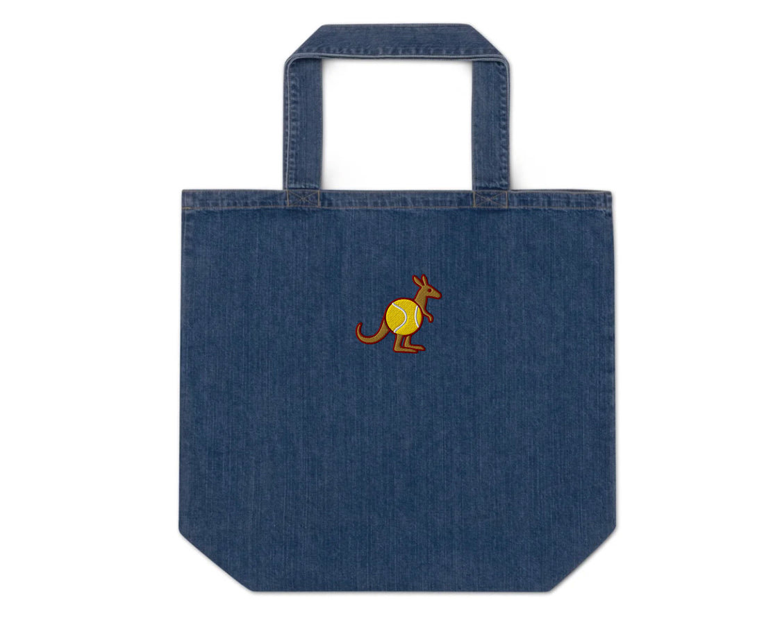 Blue organic denim tote bag with embroidered Skippy kangaroo holding a tennis ball – front view
