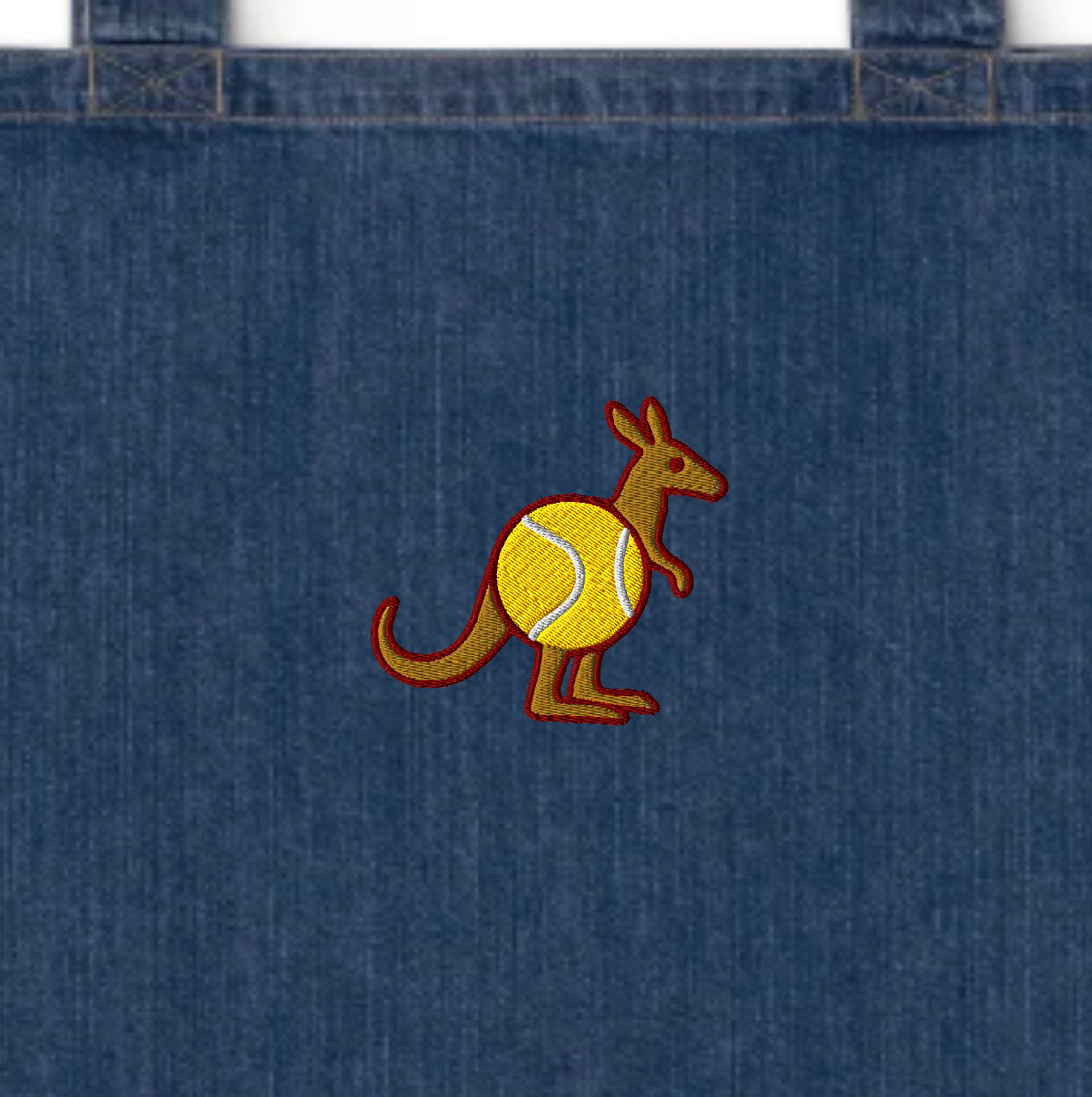 Close-up of blue denim tote bag top seam and dual handles – cross-stitch detail