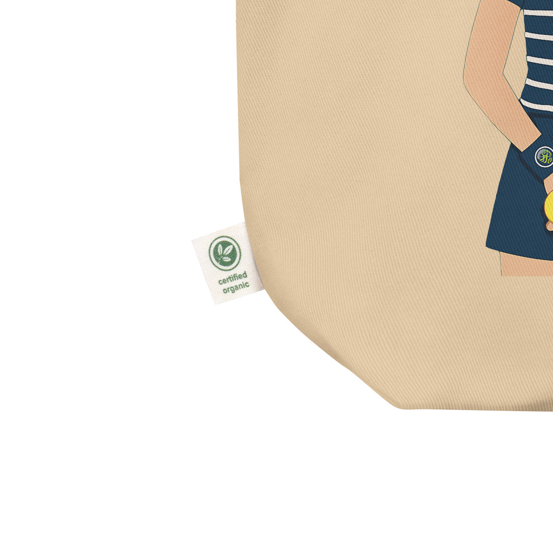 Angled close-up certified organic tag of natural cotton tote bag seams and “Ball kids” graphic